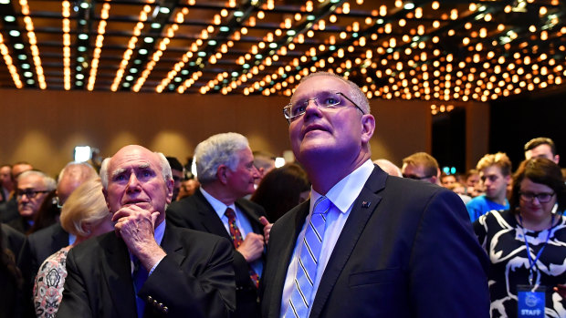 Prime Minister Scott Morrison and former prime minister John Howard await the result of the NSW election in Sydney.