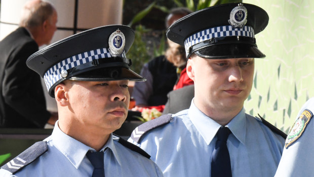 Senior Constable Frederick Tse (left) and Senior Constable Jakob Harrison arrive at the Coroner's Court in Lidcombe on Tuesday. 