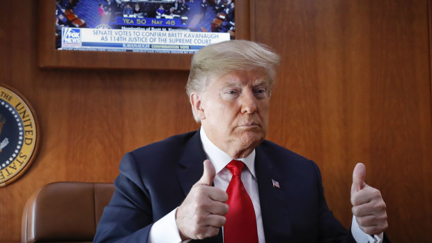 President Donald Trump, on board Air Force One, gives a 'thumbs-up' while watching a live television broadcast of the Senate confirmation vote of Supreme Court nominee Brett Kavanaugh on Saturday.