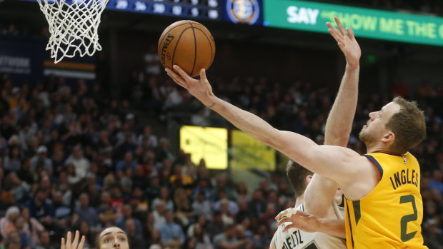 Prime time: Joe Ingles lays the ball up for Utah Jazz as San Antonio Spurs center Jakob Poeltl defends.
