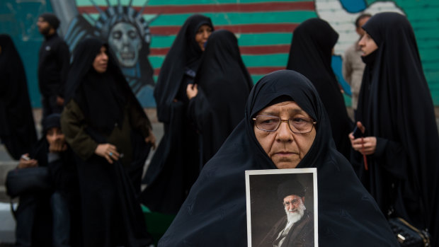 A woman holds a picture of Ayatollah Khamenei, Iran's supreme leader. Iran says fresh US sanctions only serve to make it more productive and self-sufficient.