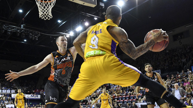 Peripheral vision: Jerome Randle seeks to pass around Andrew Ogilvy of the Hawks at the WIN Entertainment Centre.