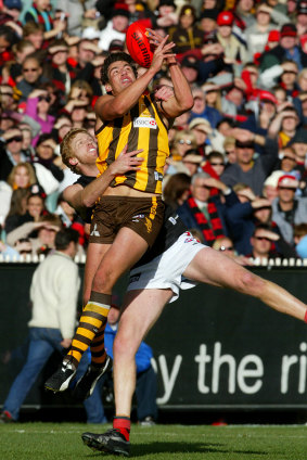 Hawthorn’s Nathan Thompson marks over Essendon’s Dustin Fletcher.