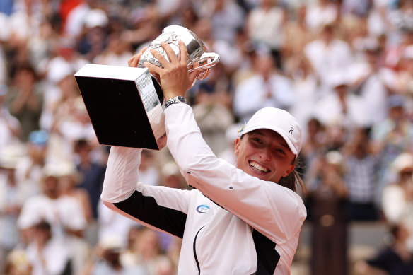 Iga Swiatek of Poland celebrates with her trophy after victory against Karolina Muchova of Czech Republic.