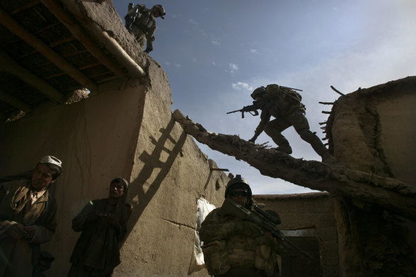 Australian soldiers search a house for weapons, explosives and Taliban fighters during a foot patrol in Chora, Afghanistan, in 2009.