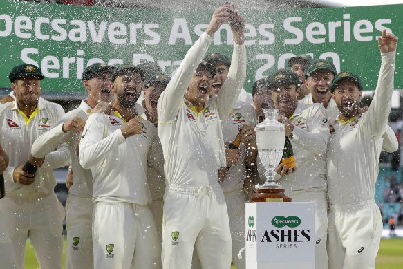 The Australian team, including Peter Siddle, celebrate with a replica of the Ashes at the Oval in September.