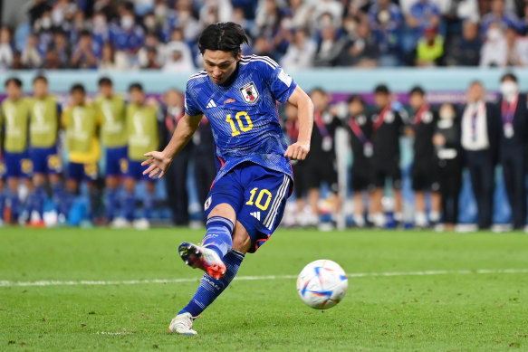 Takumi Minamino of Japan shoots the team’s first penalty saved by Dominik Livakovic.