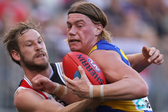 Harley Reid of the Eagles gets tackled by Jimmy Webster of the Saints.