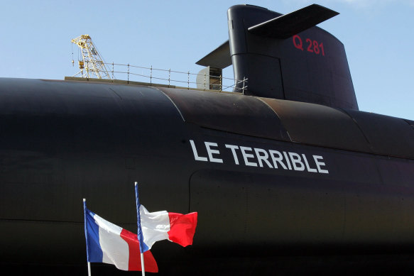 French flags fly during the launch of the country’s  nuclear-powered submarine, “Le Terrible”, in Cherbourg. There have been terrible ructions between France and Australia since the AUKUS alliance was announced.