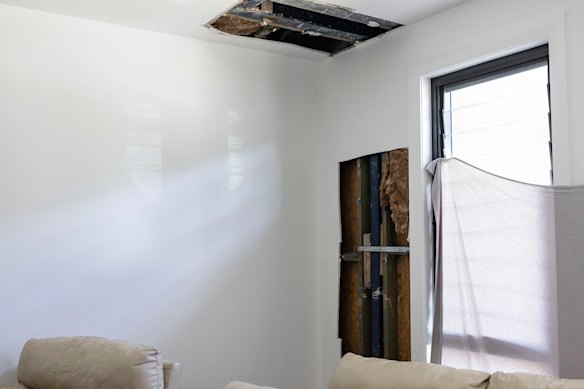 Amanda Owen’s lounge room with holes in the ceiling and wall.