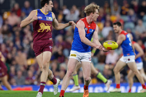 Harrison Petty of the Demons handpasses the ball during the match.