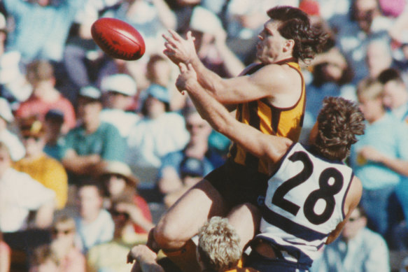 Dunstall flies for a mark over Geelong’s Mark Yeates and Tim Darcy.