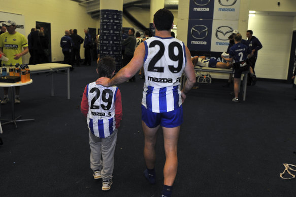 Brent Harvey with son Cooper after a game in 2010.
