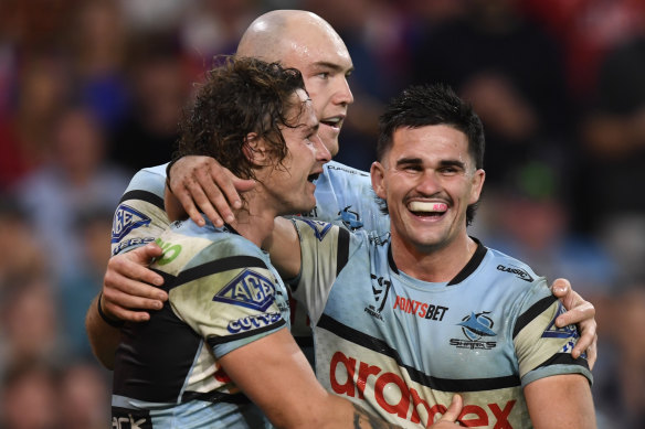 Daniel Atkison (right), Nicho Hynes and Tom Hazleton (centre) celebrate a try against the Roosters.