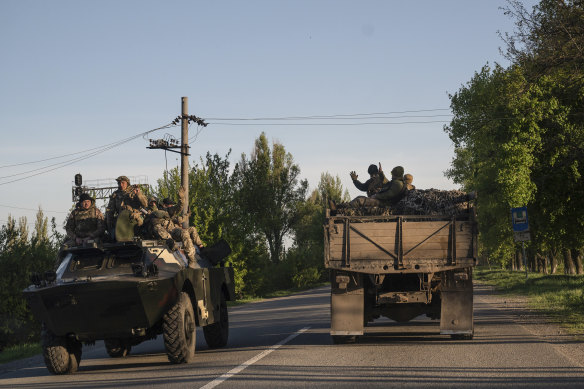 Ukrainian soldiers greet each other along the road near Pokrovsk in the Donbas region of Ukraine. 