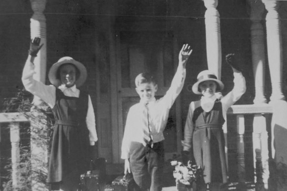 John Egan, in one of his 10 school uniforms, again with his sisters. 