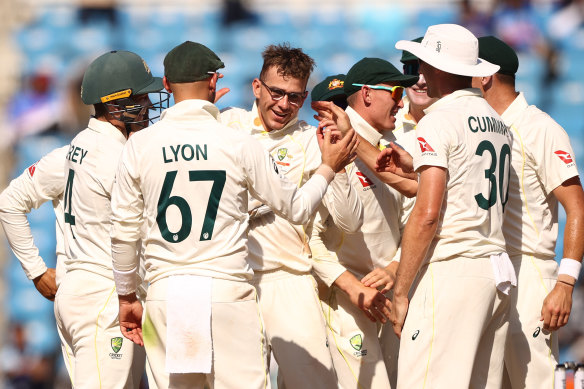 Todd Murphy is congratulated by teammates after taking his fifth wicket during day two.