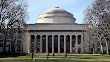 Students walk past the "Great Dome" atop Building 10 on the Massachusetts Institute of Technology campus in Cambridge, Massachusetts. 