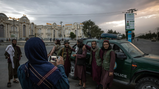 Taliban fighters strike a pose outside the Kabul international airport.