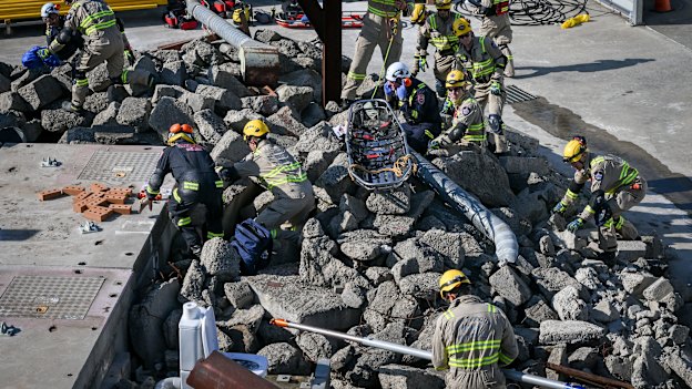 Urban search and rescue teams look for survivors in the rubble.