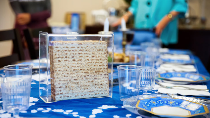 A family gathers around a seder table during Passover.