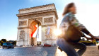 Arc de Triomphe in Paris with a big French flag under it 