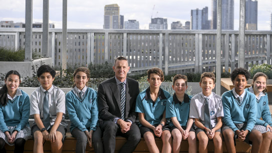 Prahran High School principal Nathan Chisholm and students on the rooftop garden