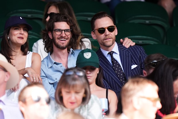 Tom Hiddleston with Andrew Garfield and Monica Barbaro at the 2026 Wimbledon Championships at the All England Lawn Tennis and Croquet Club, London. Saturday July 4, 2026.
