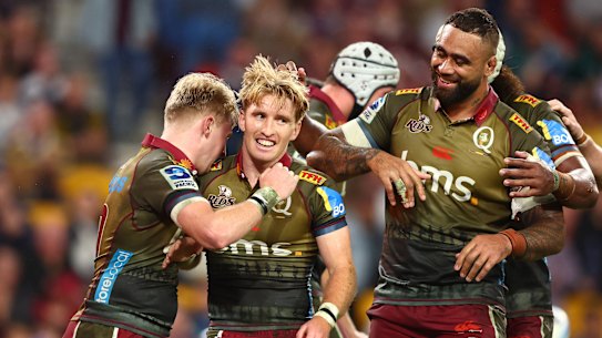 Tate McDermott of the Reds celebrates a try during the round 11 Super Rugby Pacific match between Queensland Reds and Blues at Suncorp Stadium.
