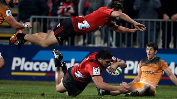 High point: Codie Taylor dives over for the first and only try on Saturday as Crusaders teammate George Bridge is airborne.