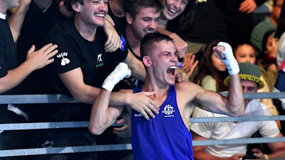 Harry Garside celebrates after defeating India's Manish Kaushik in the men's 60kg boxing final.