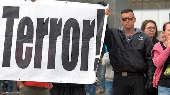 Protesters gather for a far-right protest in front of a Karl Marx monument in Chemnitz, Germany.