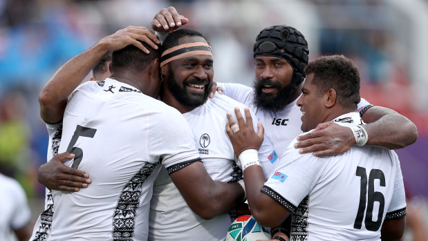 Second-tier treatment: Apisalome Ratuniyarawa of Fiji celebrates with teammates after scoring his team's sixth try against Georgia.