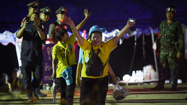Thai volunteers cheering as they return from Tham Luang cave after all 13 have been rescued. 