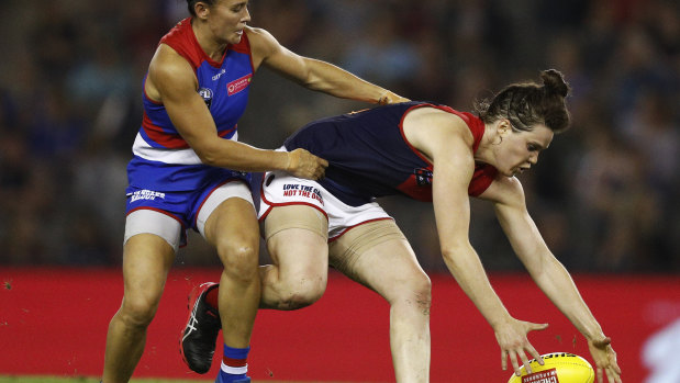 Possessed: Demon Elise O'Dea (right) attempts to evade a tackle during Melbourne's narrow win over the Western Bulldogs on Saturday night.