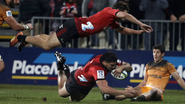 High point: Codie Taylor dives over for the first and only try on Saturday as Crusaders teammate George Bridge is airborne.