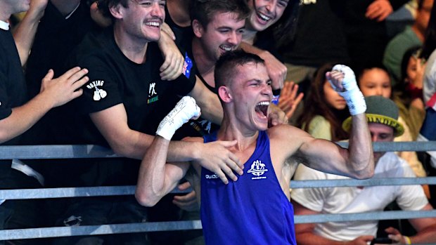 Harry Garside celebrates after defeating India's Manish Kaushik in the men's 60kg boxing final.