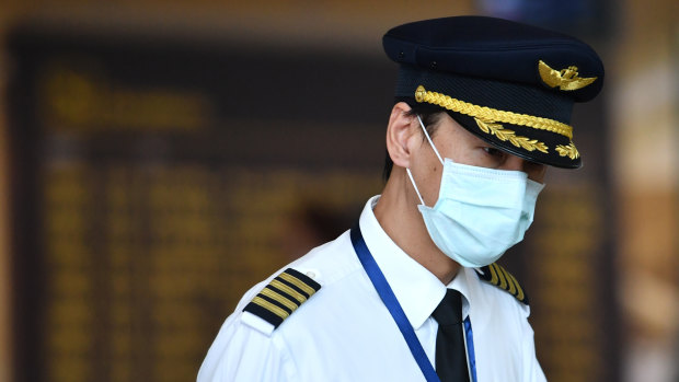 An airline crew member wears a mask at Brisbane International Airport in January.