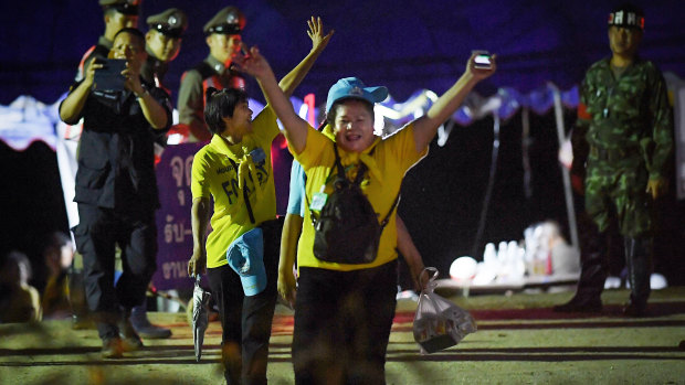 Thai volunteers cheer as they return from Tham Luang cave after the group was rescued. 