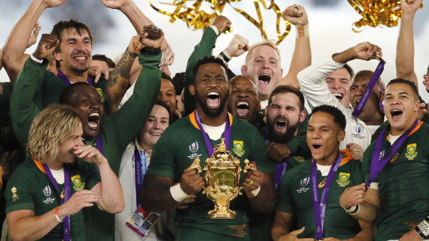Siya Kolisi lifts the Rugby World Cup trophy after victory in 2019.