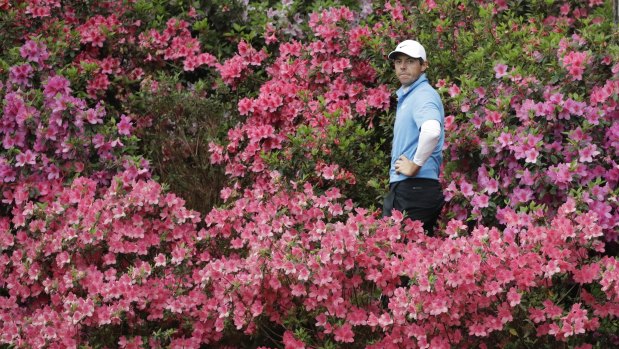 Rory McIlroy, of Northern Ireland, hits from the azaleas during the third round.