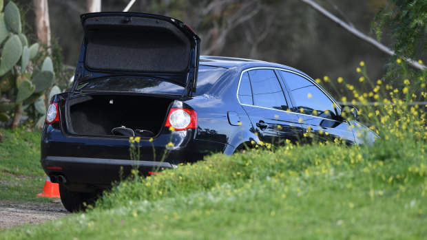 A Volkswagen, believed to have been driven by the suspect, down the road from the rammed police car. 