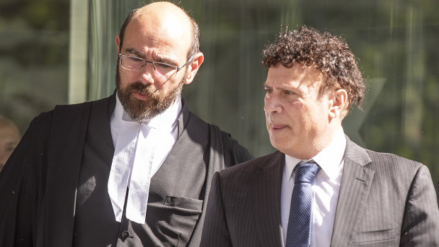 Nino Napoli (right) leaves a directions hearing at the County Court on Friday.