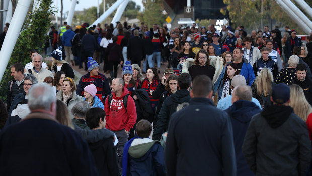 Fans walk the Matagarup Bridge before the first preliminary final between Melbourne and Geelong at Optus Stadium. 