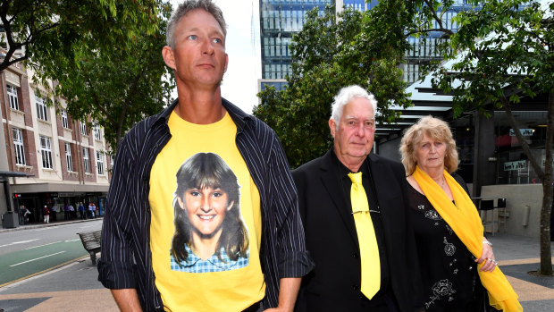 Kevin Mason (left), is seen wearing a T-shirt displaying a photograph of his sister Annette Mason, next to her father, Mick Mason (centre) outside the Brisbane Coroners Court in Brisbane on Monday.