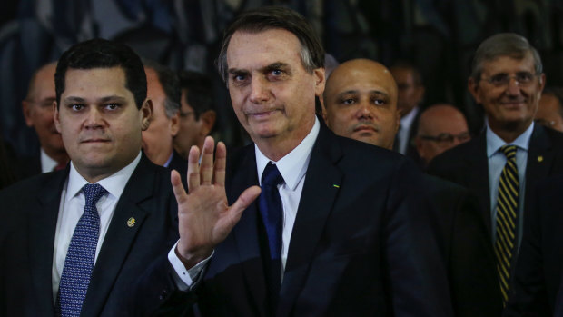 Brazilian President Jair Bolsonaro, centre, has vowed to eliminate "leftist influences" in schools.