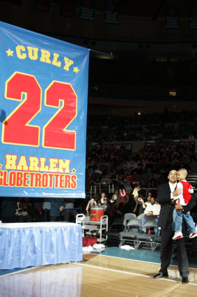 Fred Neal with his grandson in 2008, after his number was retired by the Globetrotters.