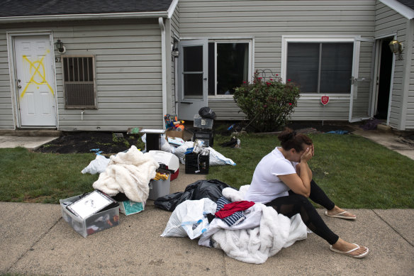 Connie Leon, 16, cries outside her flood-damaged home as a clean-up effort starts in the north-eastern US.