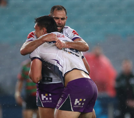 Cameron Smith and Tino Faasuamaleaui  celebrate the latter's crucial try for the Storm on Friday night.
