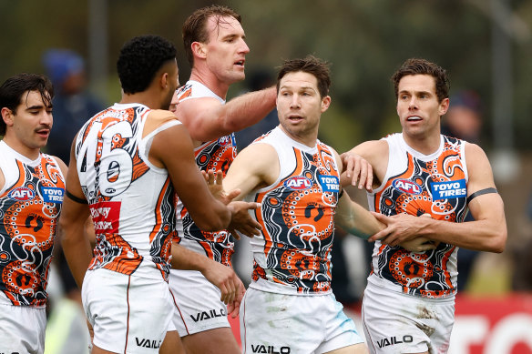 Toby Greene celebrates a goal with teammates.